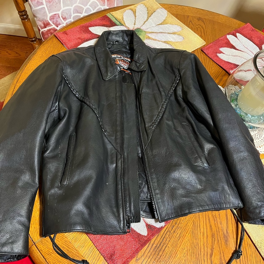 Two leather jackets and a pair of jeans
